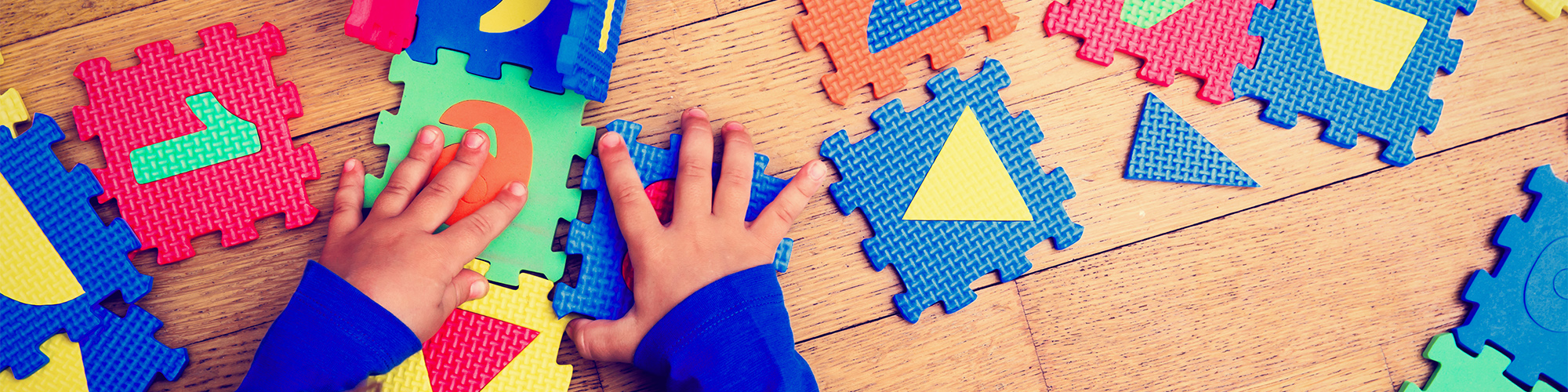 Child Playing With a Large Puzzle